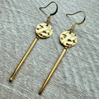 Gold hammered disc with dangle bar.